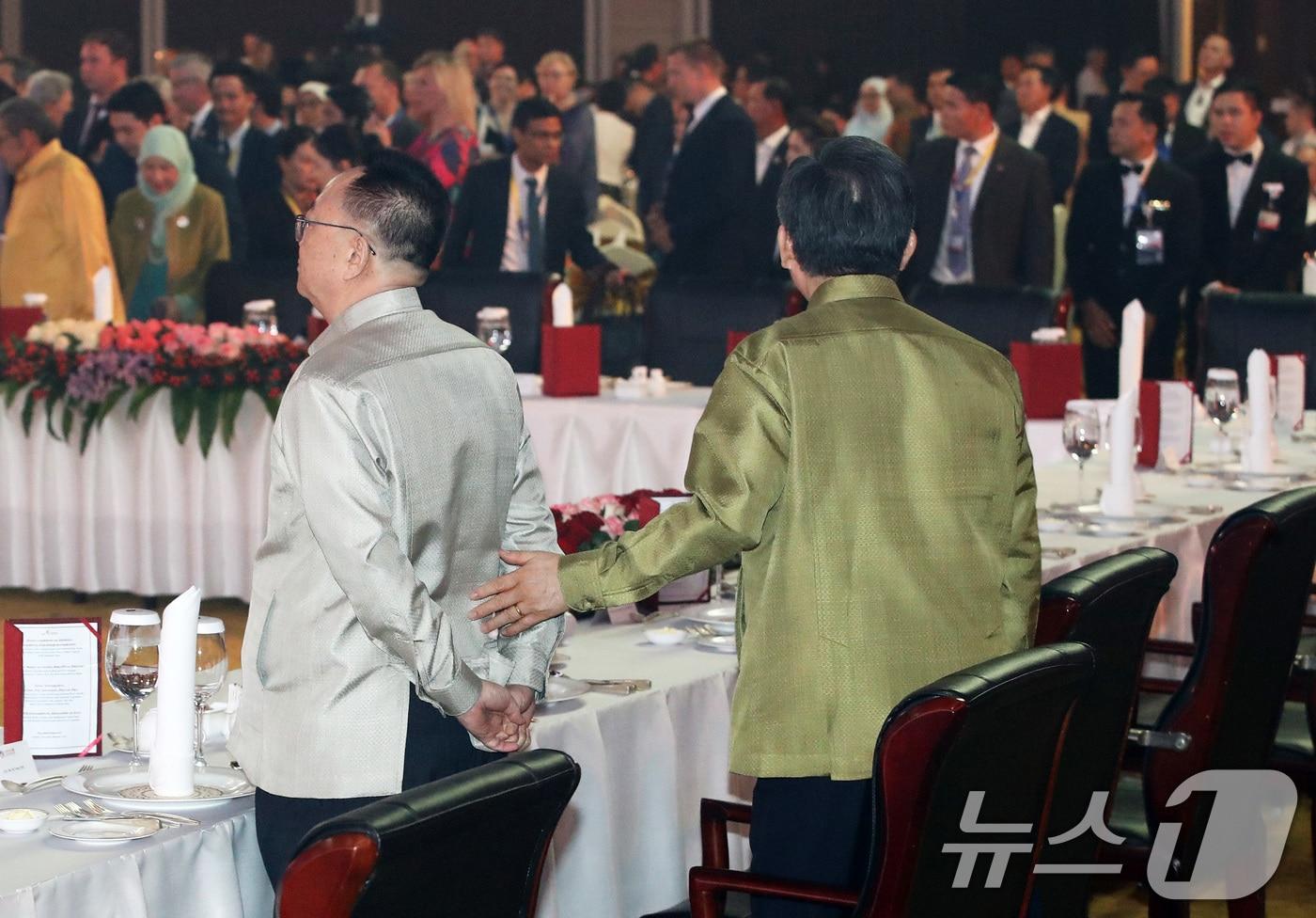 South Korean Foreign Minister Cho Tae Yul approaches North Korean Ambassador to Laos Ri Yong Chol as he speaks to him during the gala dinner of the 57th Association of Southeast Asian Nations &#40;ASEAN&#41; Foreign Ministers&#39; Meeting at the National Convention Center &#40;NCC&#41; in Vientiane, Laos, on July 26 last year.