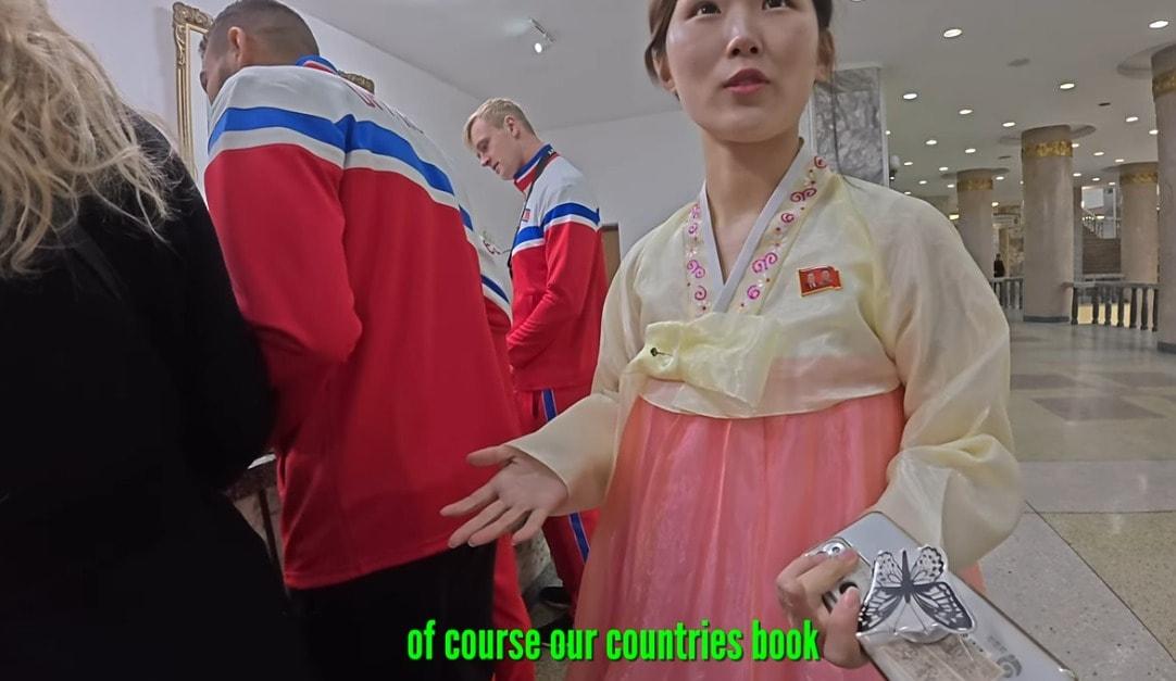 A North Korean employee answers questions from foreign tourists at the Pyongyang National Library.