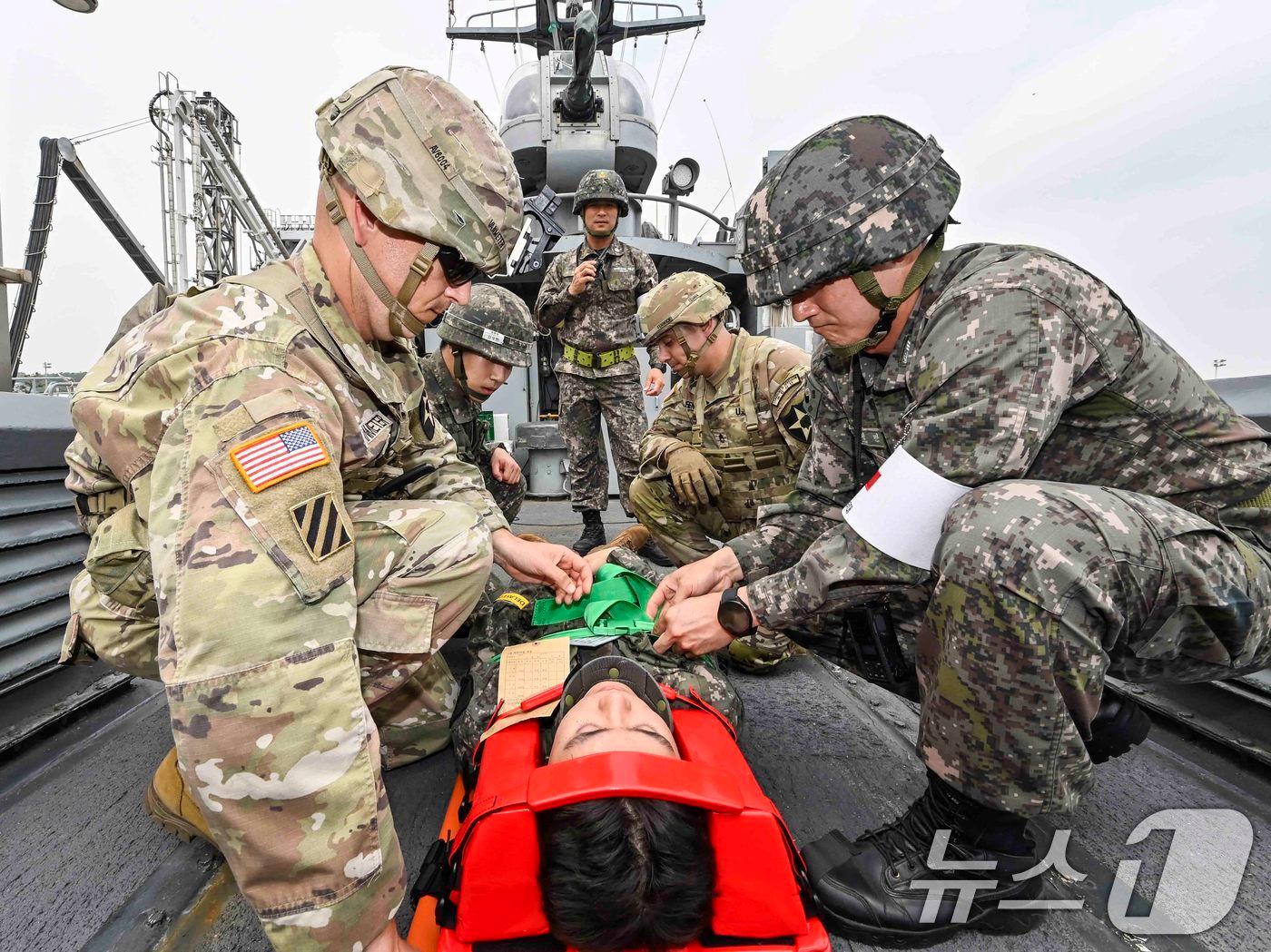 During a combined joint medical support exercise last month, South Korean and U.S. troops secured a Marine with a spinal injury to a stretcher for evacuation via high-speed boat. / Photo courtesy of ROK-US Combined Forces