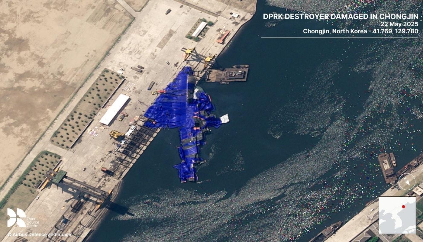 A newly built North Korean destroyer, damaged during the launching process, is seen listing at sea after losing balance / Screenshot from the social media platform X, account MenchOsint