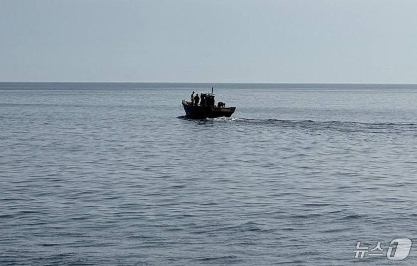The government repatriated six North Korean residents on Wednesday who had been drifting in the East and West Seas and staying in South Korea. The image shows the residents returning to North Korea on a wooden boat. / Photo courtesy of the Ministry of Unification