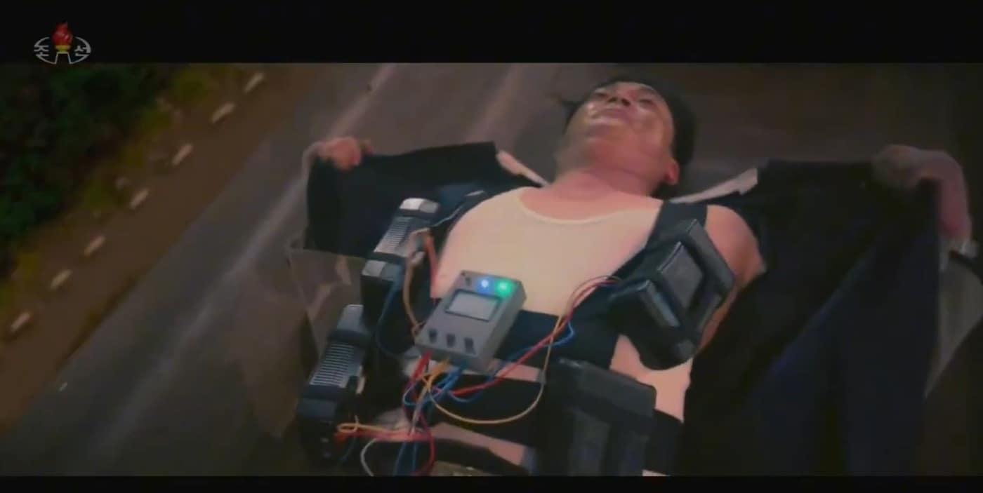 A scene from the North Korean film Day and Night of Confrontation where the protagonist wears a bomb vest / Capture from Korean Central Television