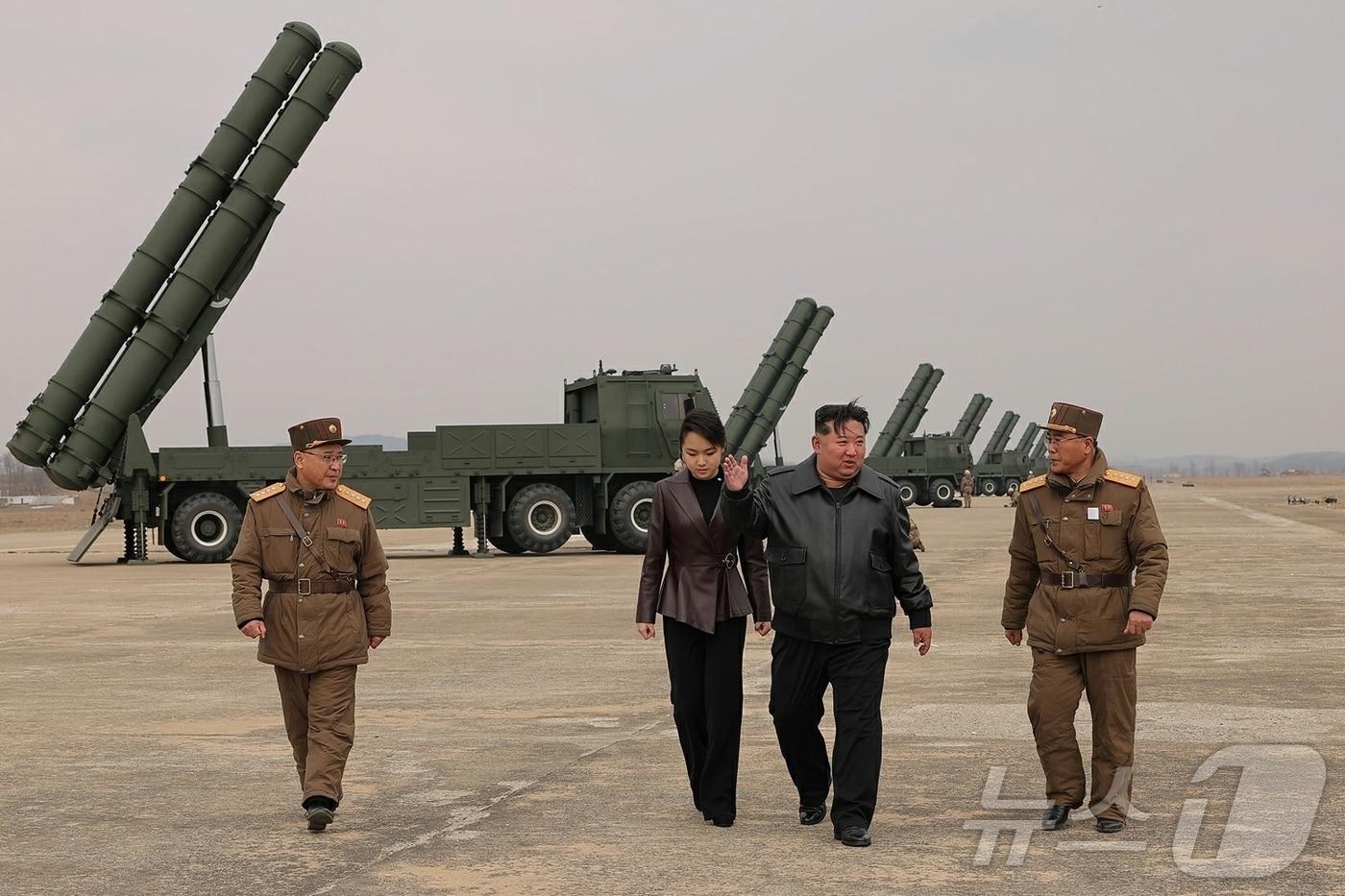 Kim Jong Un, General Secretary of North Korea's Workers' Party, and his daughter Ju Ae attended the test-firing of a super-large multiple rocket launcher on March 14 / Rodong Sinmun