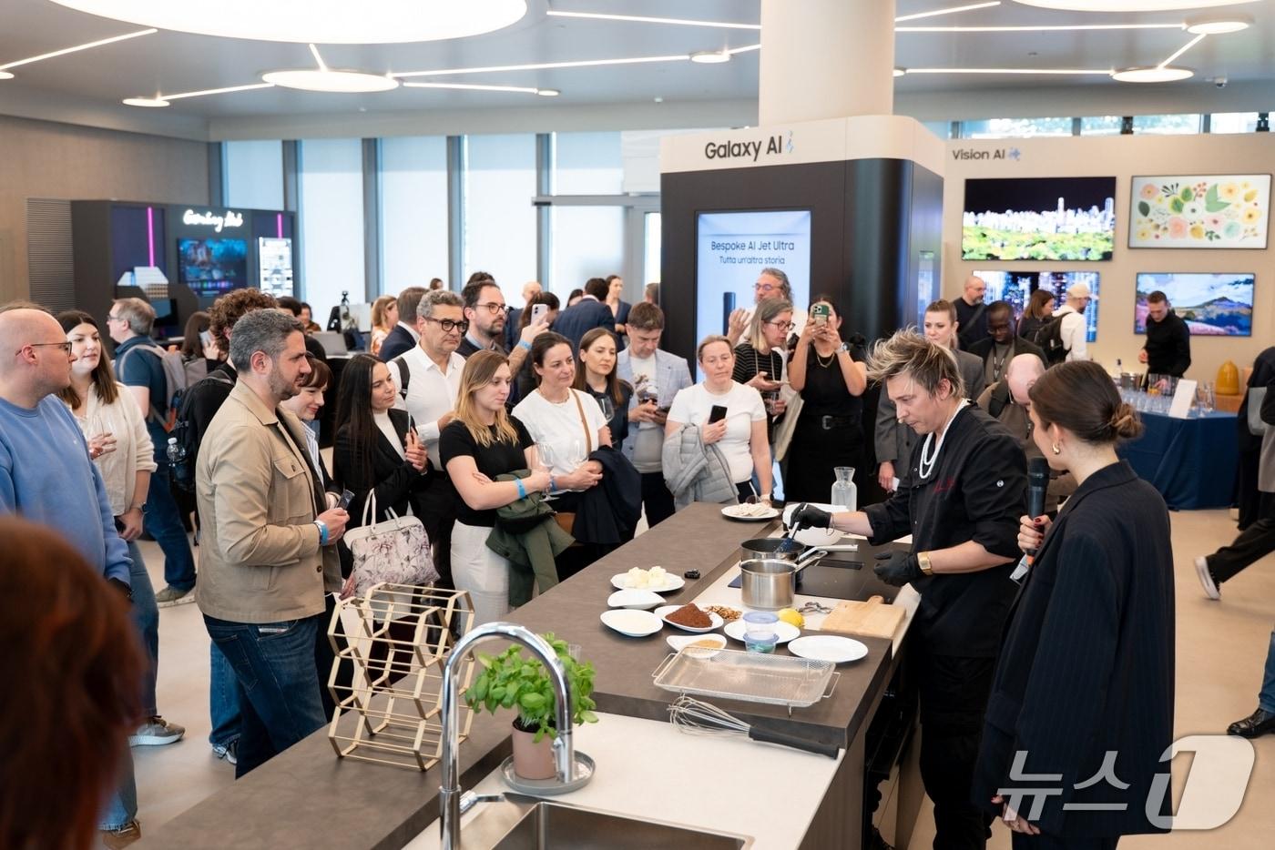 Attendees are trying out the new integrated hood induction cooktop at Samsung Electronics' home appliance technology seminar, The Brief Milan, held in Milan, Italy, on Tuesday / Provided by Samsung Electronics